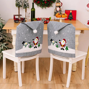Gray chair cover with Santa and snowman applique, pom-pom top, and falling snow detail.