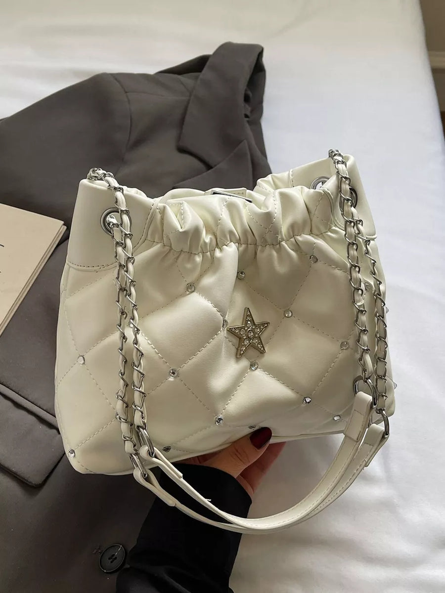 White quilted shoulder bag with diamond pattern, rhinestone accents, and a star embellishment.