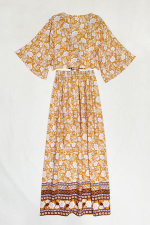 Bohemian floral crop top and maxi skirt set in tangerine with wide sleeves and a tie waist.