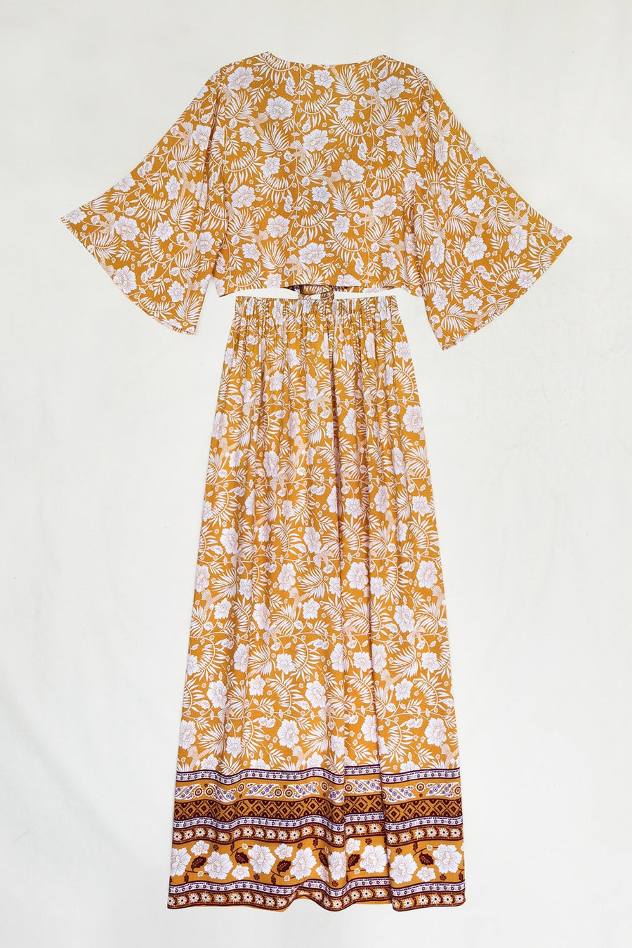 Bohemian floral crop top and maxi skirt set in tangerine with wide sleeves and a tie waist.