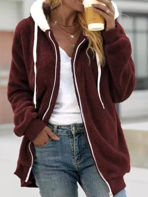 Maroon fleece zip-up hoodie with white trim and drawstring, worn open over a white top.