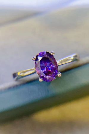 Oval cut amethyst solitaire ring with silver band