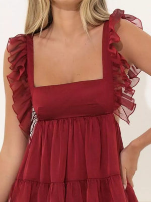 Brick red mini dress with square neck and sheer ruffled cap sleeves.