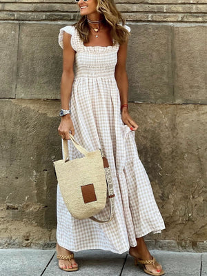 Beige gingham ruffled sleeve maxi dress with smocked bodice and tiered skirt.
