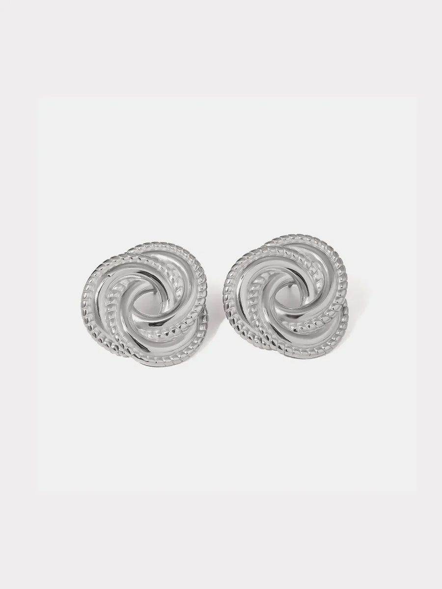 Silver swirl knot stud earrings with textured rope edge detail