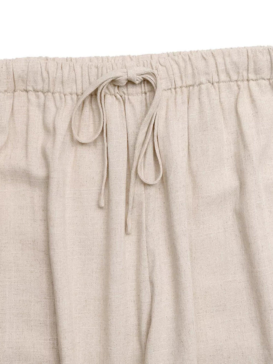 Relaxed drawstring wide-leg trousers in natural linen with a tie waist.