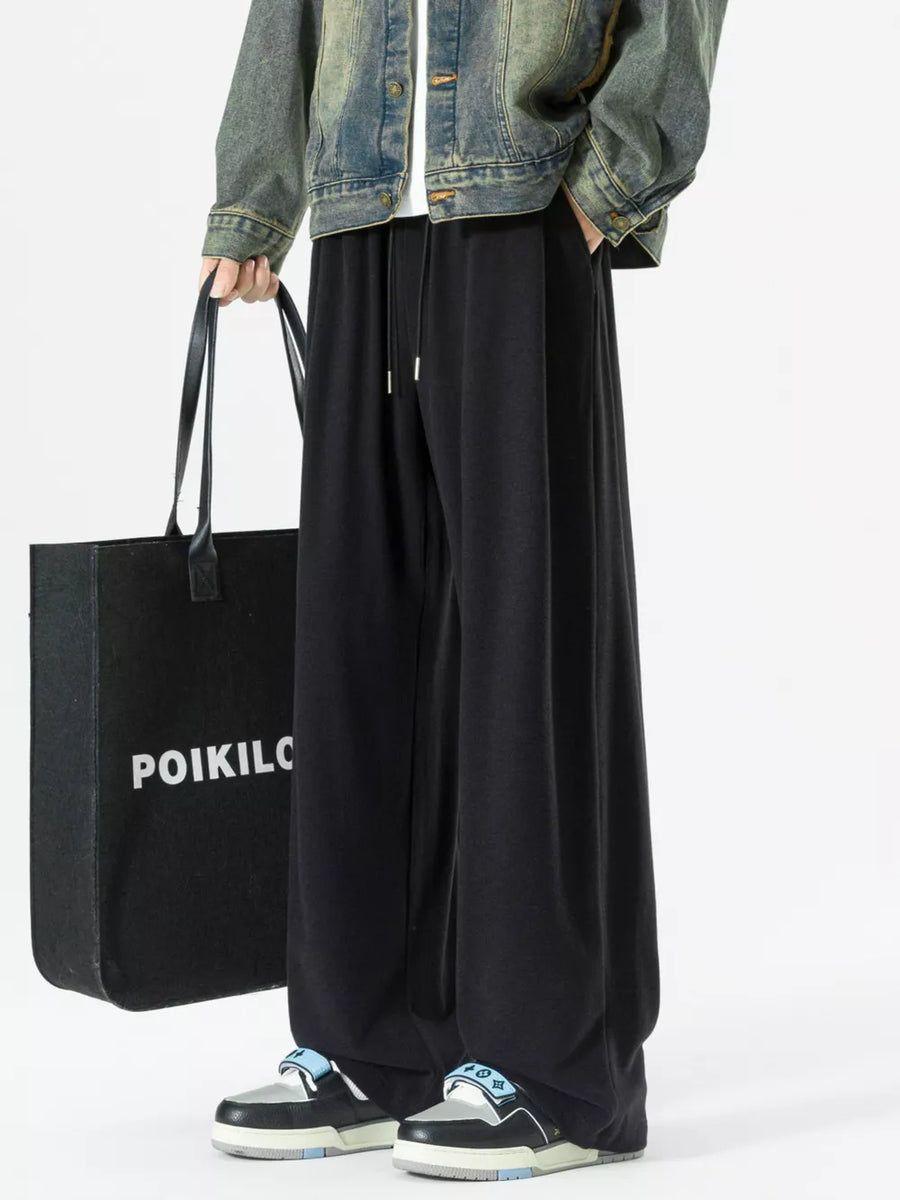 Black relaxed fit drawstring sweatpants with pockets and a wide leg.