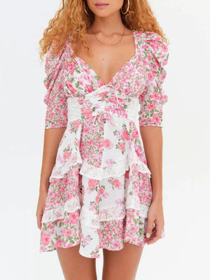 Pink floral tie-front dress with ruched half sleeves and tiered lace trim skirt.