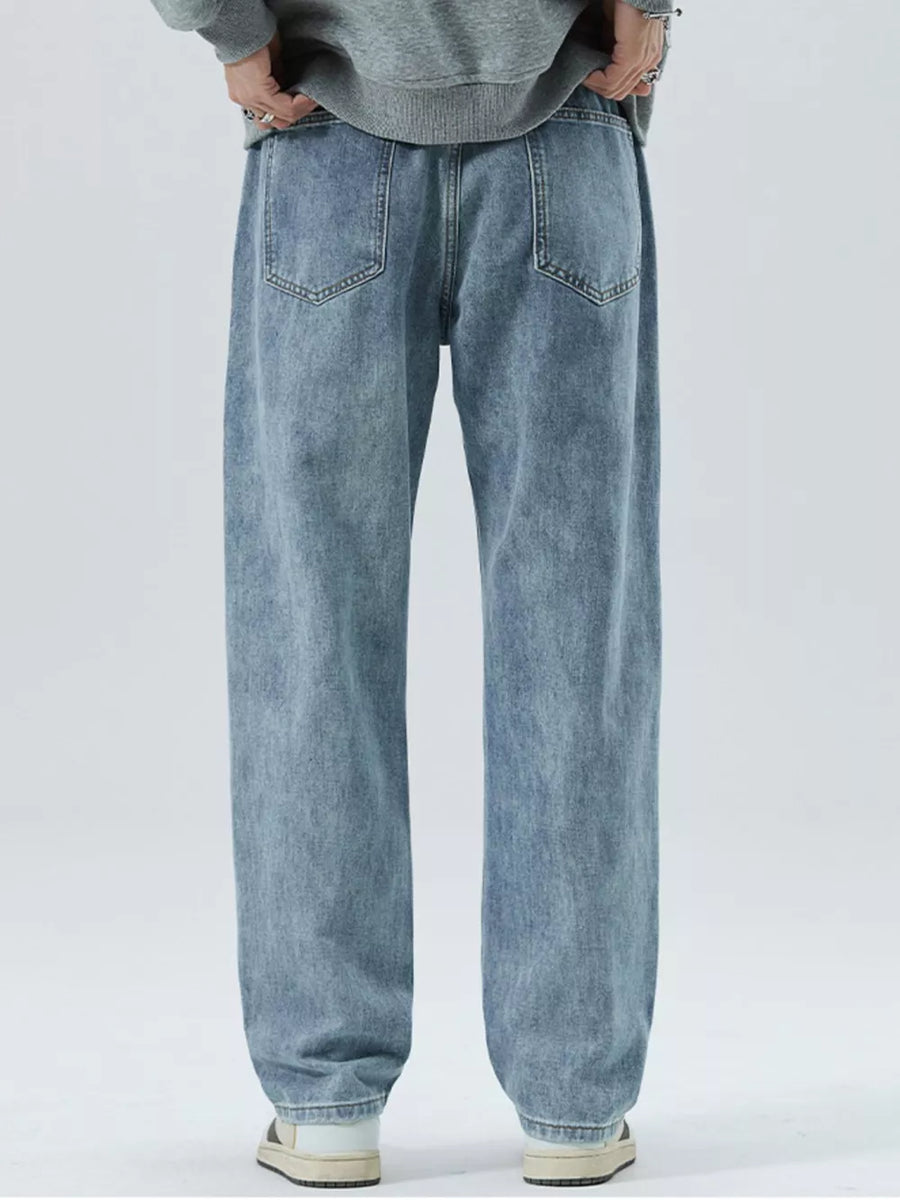 Light blue 100% cotton men's loose-fit jeans with drawstring waist and back pockets.
