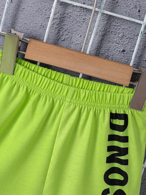 Neon green toddler shorts with black dinosaur text and elastic waistband.