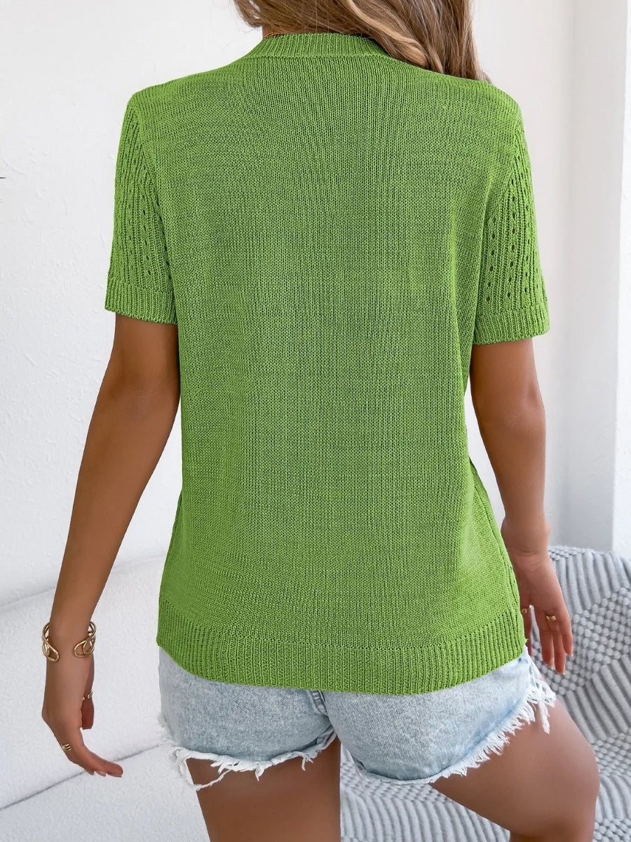 Green knit button-up cardigan with short sleeves and open knit detail on sleeves