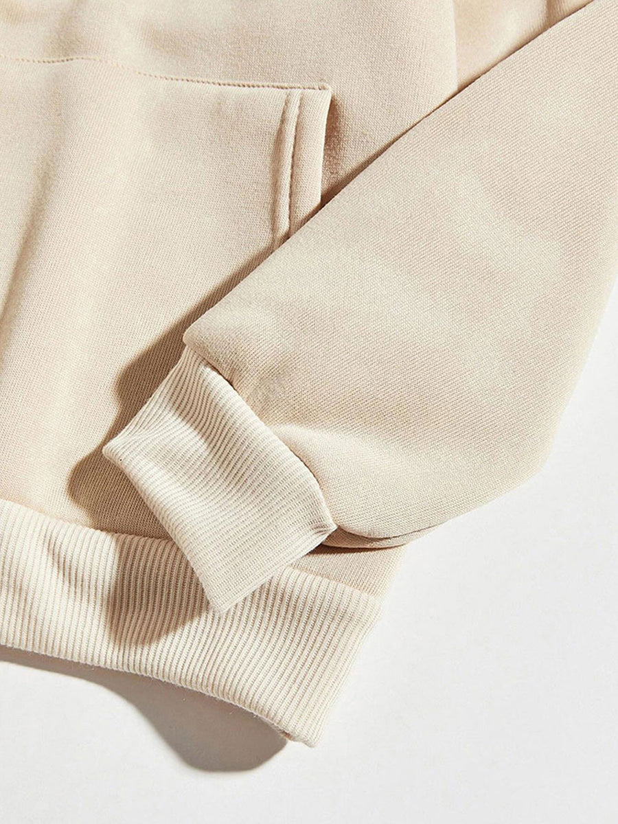 Cream hoodie with ribbed cuffs and hem, featuring a front pocket detail.