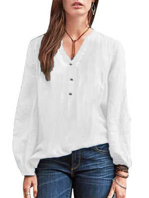 White long-sleeve blouse with notched neckline and button detail