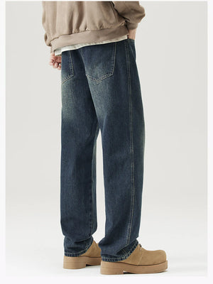 Relaxed fit vintage wash jeans in blue denim with a faded look.