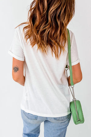 White crewneck tee with rolled sleeves and a subtle eye tattoo on the arm.