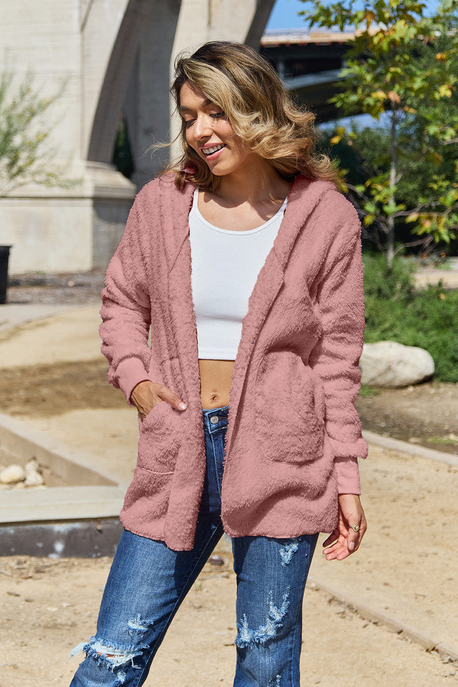 Plush hooded cardigan jacket in blush pink with open front and pockets.