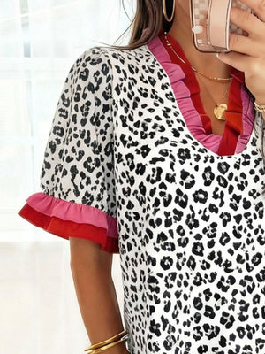 Ruffled leopard print blouse with pink and red trim on sleeves and neckline.