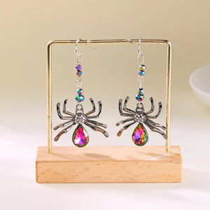 earrings featuring spider motif in Heliotrope Purple with Alloy,Crystal,Silver-plated Care instructions: Avoid wearing