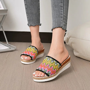 Zigzag embroidered espadrille platform slides with braided jute trim and wedge heel.