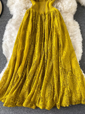 Yellow lace maxi dress with ruffled neckline and flowing skirt.