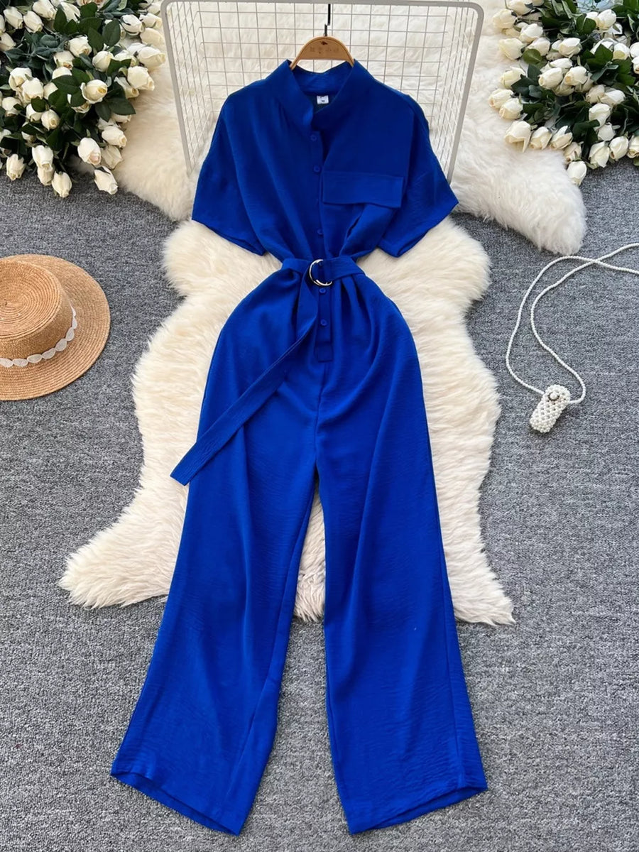 Blue belted wide leg romper with button-down front and short sleeves.