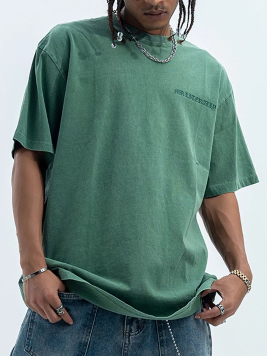 Green oversized graphic tee, 100% cotton, with a subtle front graphic and relaxed fit.