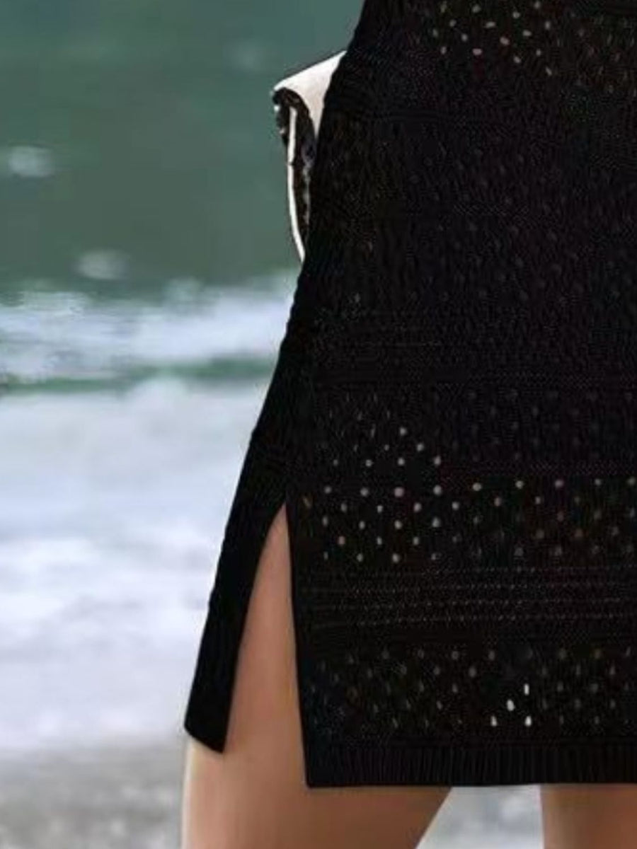 Black open-knit beach dress with slit hem and sheer details.