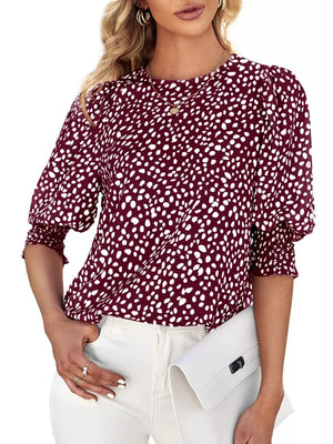 Burgundy animal print blouse with half sleeves and ruched cuffs.