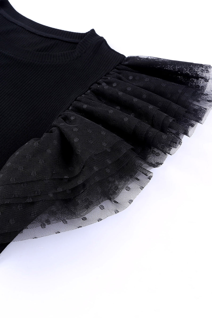 Black ribbed knit blouse with ruffled dot mesh sleeves.