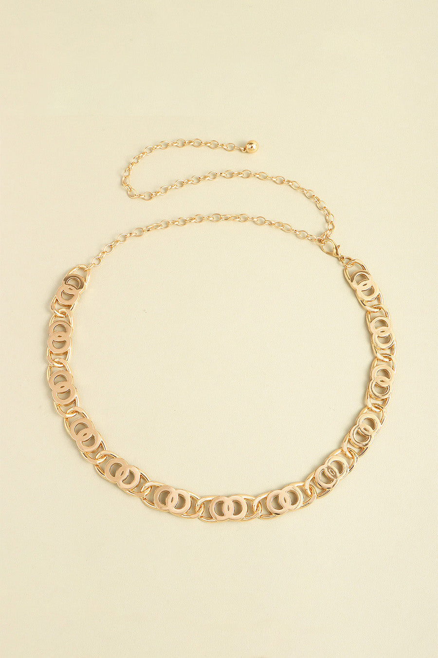 Golden chain belt with interlocking circle links and adjustable extender chain.