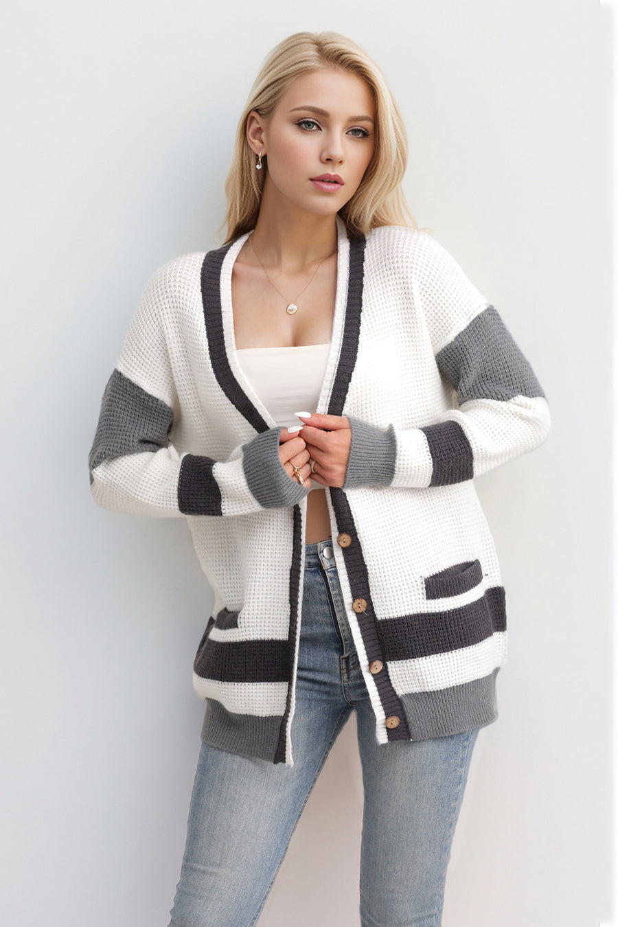 White waffle knit cardigan with grey stripes and long sleeves