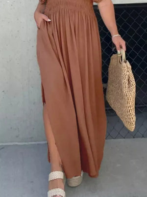 Brown V-neck maxi dress with smocked waist, dolman sleeves, and side slits.