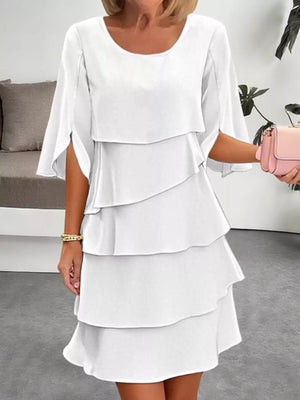 White ruffled layered flutter sleeve dress with tiered skirt and split sleeves.