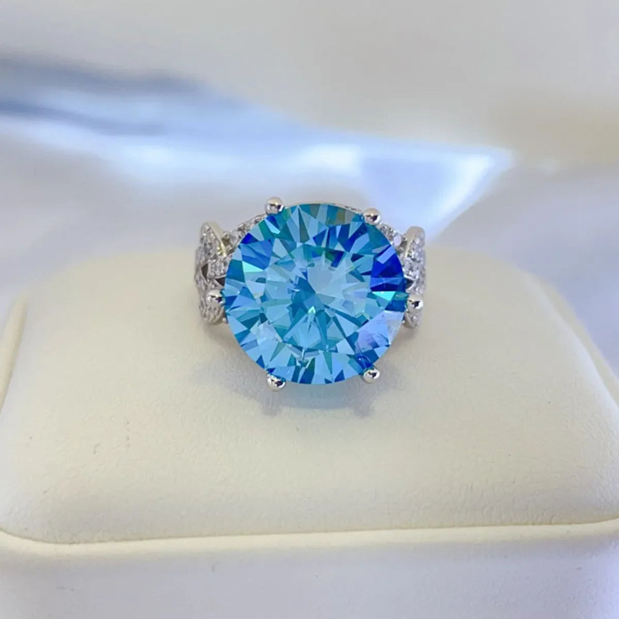 Celestial blue moissanite knot ring with pavé accents and a large round-cut blue stone.