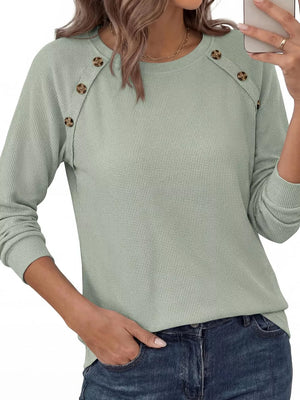 ivory t-shirt with decorative buttons and long sleeve