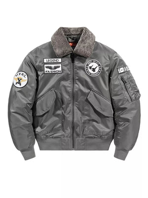Gray bomber jacket with shearling collar and embroidered patches.
