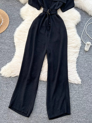 Black belted wide leg romper with button front and ring buckle belt.