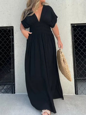 Black V-neck maxi dress with smocked waist and dolman sleeves.