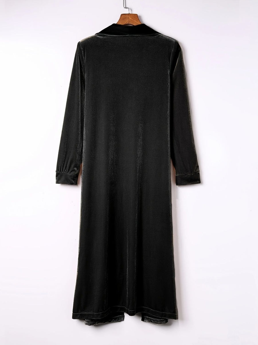 Black velvet duster coat with fluid silhouette, long sleeves and notched collar.
