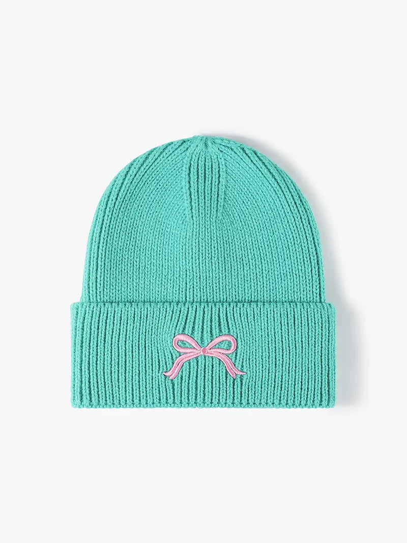 Teal ribbed knit beanie with embroidered pink bow detail