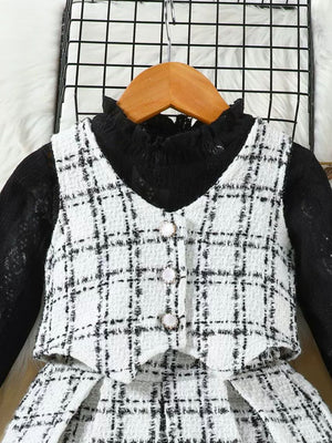 Toddler black and white plaid vest set with decorative buttons over a black lace top.