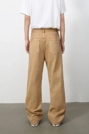 Wide-leg sandstone denim trousers with a casual, baggy fit and two back pockets.