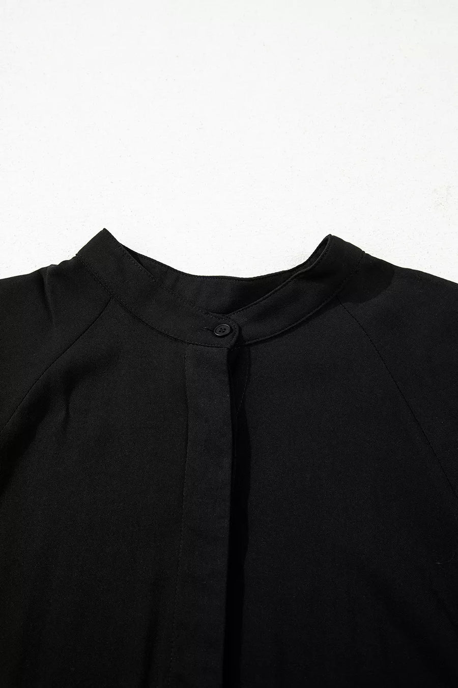 Black maternity maxi dress with mandarin collar and hidden placket detail.