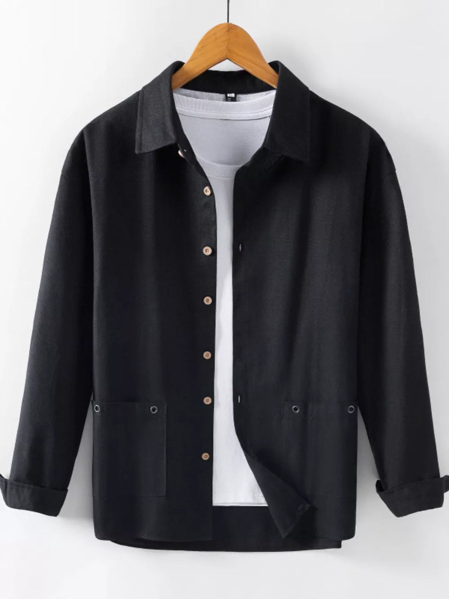 Black long sleeve button-up shirt with two chest pockets, worn over a white tee.