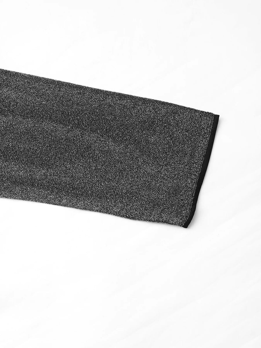 Gray glitter one-shoulder jumpsuit detail with black trim