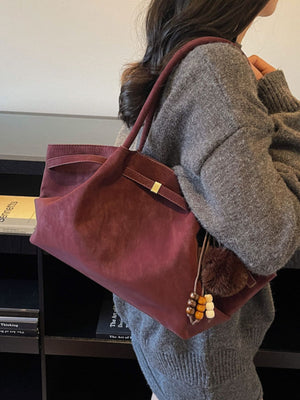 tote in burgundy featuring tassel and boxy fit