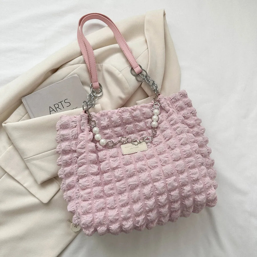 Blush pink textured grid shopper bag with pearl chain detail and chain straps.