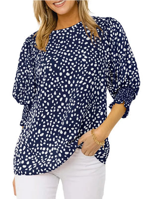Navy blue animal print half sleeve blouse with smocked cuffs.
