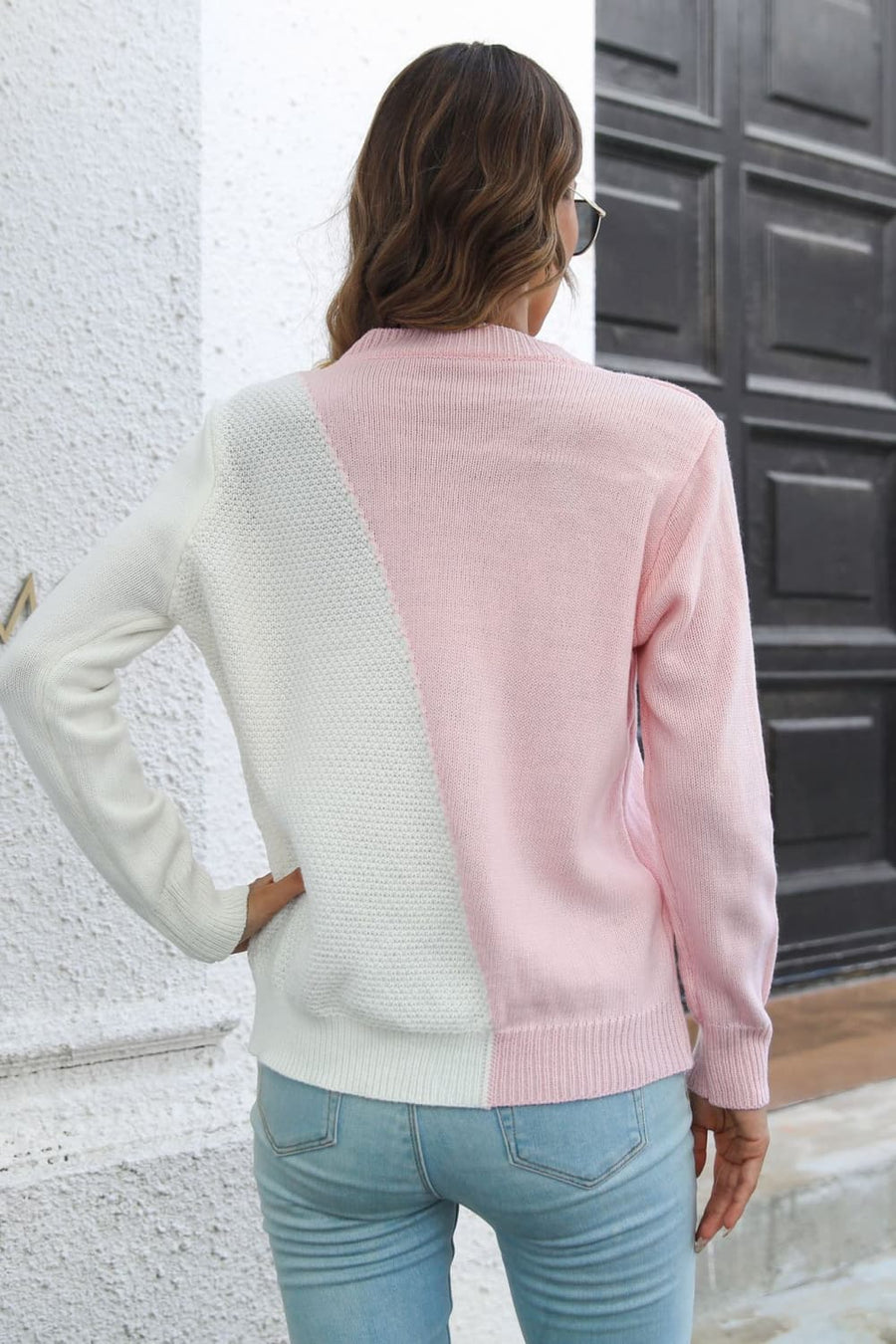 Diagonal knit sweater in white and blush pink acrylic with colorblock design.