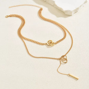 Gold layered Y-shaped pendant necklace with interlocking rings and bar detail